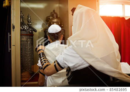 View of unknown people participating in a Bar Mitzvah ritual at the synagogue View of unknown people participating in a Bar Mitzvah ritual at the synagogue 85481695