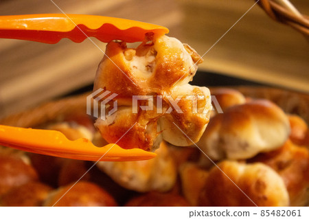 Floral bread sandwiched between tongs Floral bread sandwiched between tongs 85482061