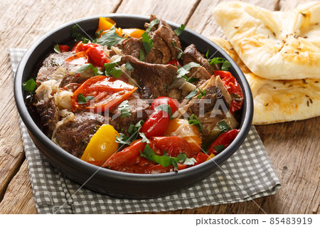 Delicious buglama meat stewed with vegetables and herbs in its own juice close-up in a bowl. horizontal Delicious buglama meat stewed with vegetables and herbs in its own juice close-up in a bowl. horizontal 85483919
