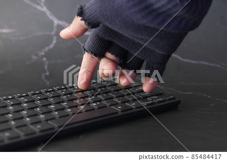 hacker hand stealing data from laptop top down hacker hand stealing data from laptop top down 85484417
