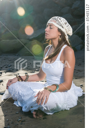 beautiful woman in the beach wearing white clothes near the sea 85485117