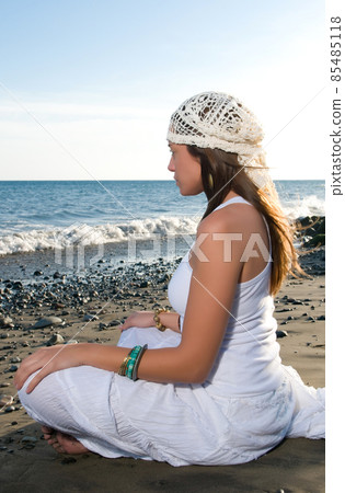 beautiful woman in the beach wearing white clothes near the sea beautiful woman in the beach wearing white clothes near the sea 85485118