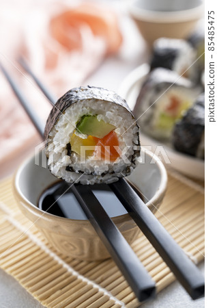 Sushi rolls close up with salmon, avocado and cucumber. 85485475