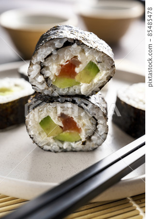 Sushi rolls close up with salmon, avocado and cucumber. 85485478