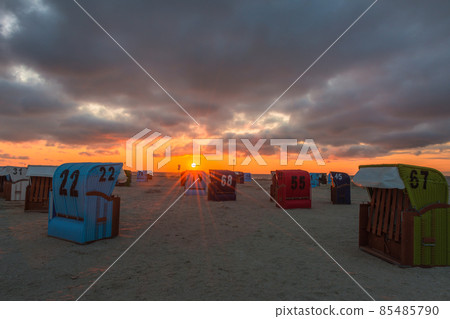 Wicker beach chairs on the North Sea at sunset, Neuharlingersiel, East Frisia, Lower Saxony, Germany Wicker beach chairs on the North Sea at sunset, Neuharlingersiel, East Frisia, Lower Saxony, Germany 85485790