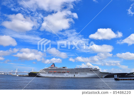White clouds floating in the blue sky and a large passenger ship moored at the large pier White clouds floating in the blue sky and a large passenger ship moored at the large pier 85486220