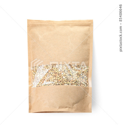 Uncooked green buckwheat grains in package isolated on white, top view. Mockup for design 85486646