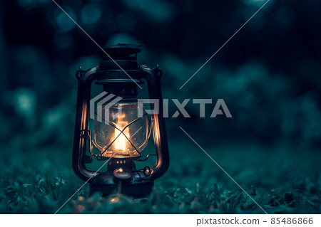 antique kerosene lamp on the grass in the forest at night.soft focus. 85486866