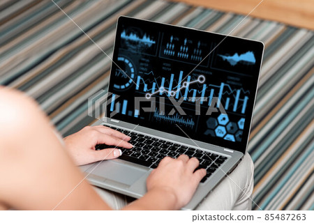 Woman Sitting With Laptop Upper Back View Actively Accomplishing Work From Home. Girl Busy Typing Inside Clean Wide House Finishing Her Remote Job Projects. Woman Sitting With Laptop Upper Back View Actively Accomplishing Work From Home. Girl Busy Typing Inside Clean Wide House Finishing Her Remote Job Projects. 85487263