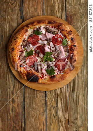 Meat Italian pizza with roast beef, steak slices, melted cheese, with olive slices and cheddar cheese. Close up, macro. Pizza time concept. Meat Italian pizza with roast beef, steak slices, melted cheese, with olive slices and cheddar cheese. Close up, macro. Pizza time concept. 85487868