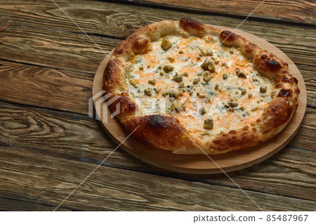 Italian Pizza Quattro formaggi on wooden table Italian Pizza Quattro formaggi on wooden table 85487967