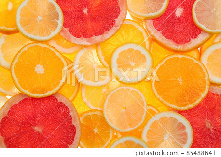 Slices of fresh tangerines and different citrus fruits on white background, top view Slices of fresh tangerines and different citrus fruits on white background, top view 85488641