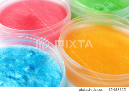 Colorful slimes in plastic containers, closeup. Antistress toy 85488835
