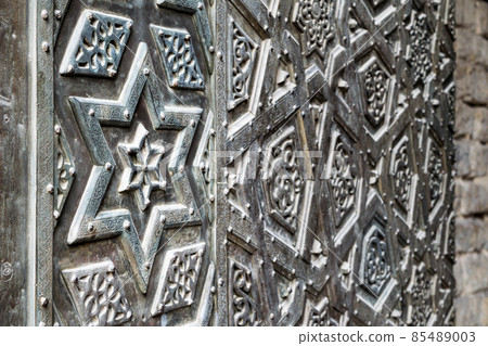 Ornaments of the bronze-plate door of an old mosque 85489003