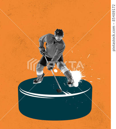 Creative design. Contemporary art collage. Man, professional hockey player standing on big puck with stick isolated over orange background Creative design. Contemporary art collage. Man, professional hockey player standing on big puck with stick isolated over orange background 85489172