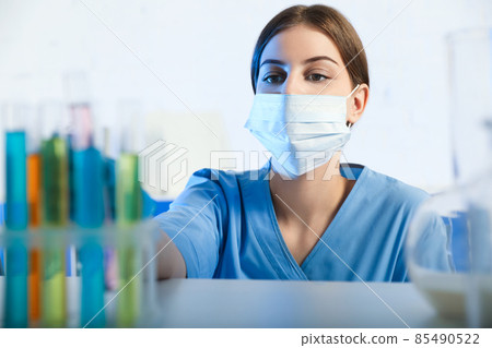 Scientist taking test tube from rack indoors. Laboratory analysis Scientist taking test tube from rack indoors. Laboratory analysis 85490522