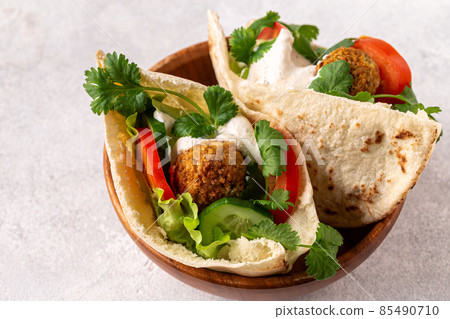 Falafel and fresh vegetables in pita bread Falafel and fresh vegetables in pita bread 85490710