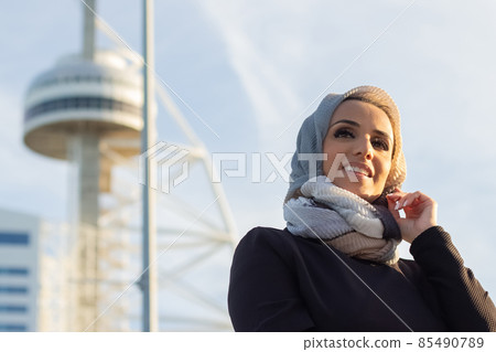Stylish smiling Arabic woman during walk 85490789