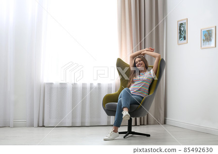 Young woman resting in armchair at home. Space for text Young woman resting in armchair at home. Space for text 85492630
