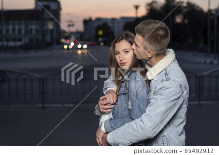 Guy hugs his beloved on evening city background Guy hugs his beloved on evening city background 85492912