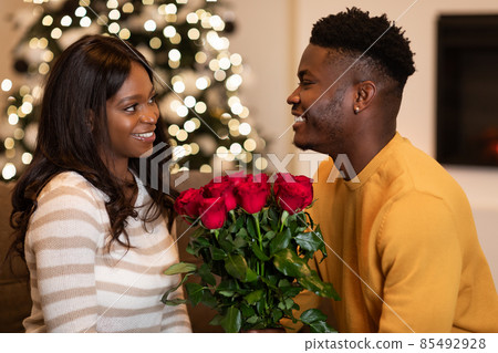 Black Husband Giving Roses To Wife On Valentine At Home 85492928