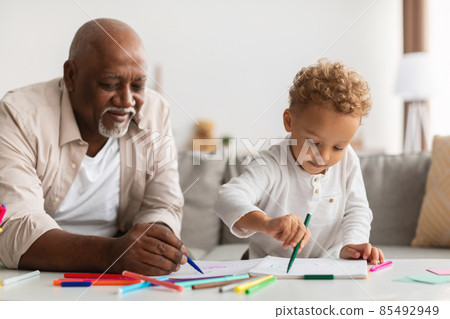 African American Grandpa And Grandson Sketching Together Drawing Picture Indoors African American Grandpa And Grandson Sketching Together Drawing Picture Indoors 85492949