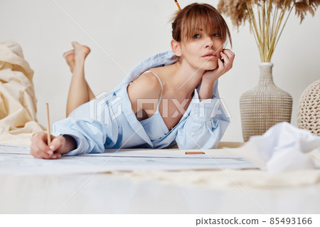 beautiful sexy woman working with blueprints at home 85493166