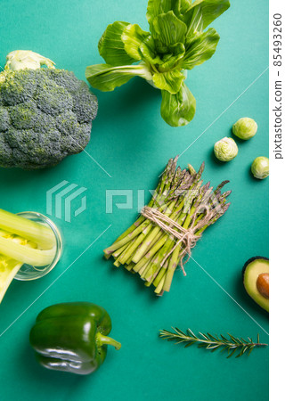 Top view set of healthy raw vegetables on the green background. Vegetarian and vegan diet. Veganism concept. Sustainable lifestyle, good, real plant-based foods. Vertical card. Top view set of healthy raw vegetables on the green background. Vegetarian and vegan diet. Veganism concept. Sustainable lifestyle, good, real plant-based foods. Vertical card. 85493260