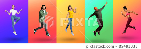Cool young diverse people jumping up and expressing excitement on color neon studio backgrounds, full length 85493333
