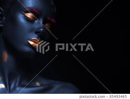 fashion portrait of a blue-skinned girl with color make-up. Beauty face. fashion portrait of a blue-skinned girl with color make-up. Beauty face. 85493465