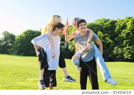 Teenage youth having fun in the park, happy laughing friends. 85493619