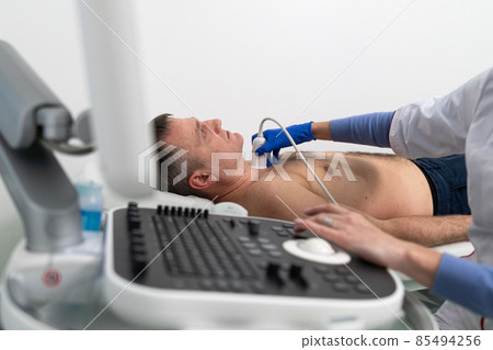 Doctor doing a doppler sonography a male patient in a cardiology clinic. Cardiologist performing an ultrasound examination at the cardiovascular hospital. Echocardiography procedure Doctor doing a doppler sonography a male patient in a cardiology clinic. Cardiologist performing an ultrasound examination at the cardiovascular hospital. Echocardiography procedure 85494256