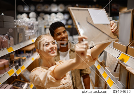Young couple buying photo frame at shop 85494653