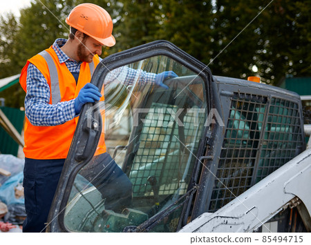 Construction worker in vehicle cab closeup shot Construction worker in vehicle cab closeup shot 85494715