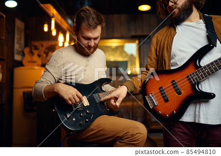 Hipster guys training play guitar enjoy rehearsal 85494810