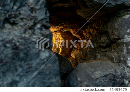embrasure in the old fortress wall through which light breaks, close-up embrasure in the old fortress wall through which light breaks, close-up 85495679
