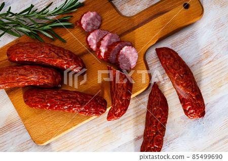 Roasted chezh sausages susena on cutting board Roasted chezh sausages susena on cutting board 85499690
