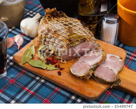 Boiled pork on chopping board with mixed peppercorns, bay leaf, cinnamon Boiled pork on chopping board with mixed peppercorns, bay leaf, cinnamon 85499747