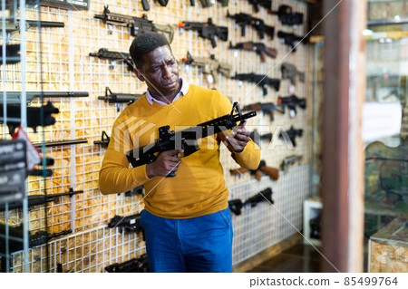 African-american man in weapon shop African-american man in weapon shop 85499764