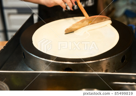 Prepare sweet crepes batter with wood, on white isolated. 85499819