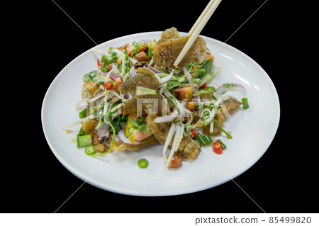 Die cut of Salad Crispy Gourami Fish with Spicy Seafood Sauce on black isolated. 85499820