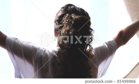 Hands pulling a window curtain for warm morning light. Slow motion. Young woman opening curtains in a bedroom. Closeup. Femele hands open window curtain in morning Hands pulling a window curtain for warm morning light. Slow motion. Young woman opening curtains in a bedroom. Closeup. Femele hands open window curtain in morning 85499966