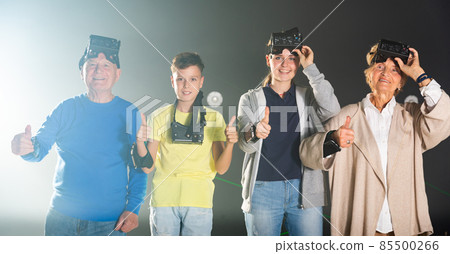 Portrait of happy family after using virtual reality glasses in quest room Portrait of happy family after using virtual reality glasses in quest room 85500266