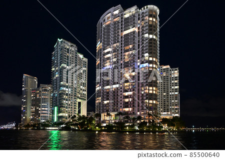 Brightly lit buildings of Miami River reflected in its water at night. 85500640
