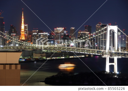 Tokyo's iconic Rainbow Bridge as seen at night from Odaiba with Tokyo Tower in the background Tokyo's iconic Rainbow Bridge as seen at night from Odaiba with Tokyo Tower in the background 85503226