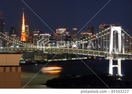 Tokyo's iconic Rainbow Bridge as seen at night from Odaiba with Tokyo Tower in the background Tokyo's iconic Rainbow Bridge as seen at night from Odaiba with Tokyo Tower in the background 85503227