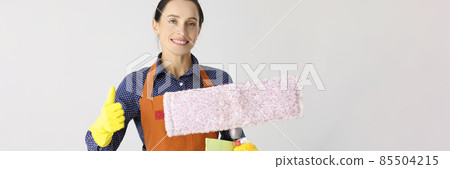 Smiling woman cleaning lady holds thumbs up Smiling woman cleaning lady holds thumbs up 85504215