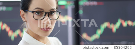 Portrait of businesswoman with glasses on background of electronic stock market analytics closeup Portrait of businesswoman with glasses on background of electronic stock market analytics closeup 85504293