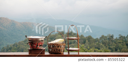 Pork or meat with vegetables and soup on the hot pan against mountain view background, Traditional Thai BBQ style is famous in Thailand 85505322