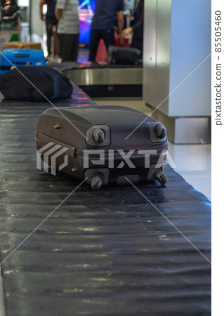 Vertical photo of suitcase on luggage conveyor belt Vertical photo of suitcase on luggage conveyor belt 85505460